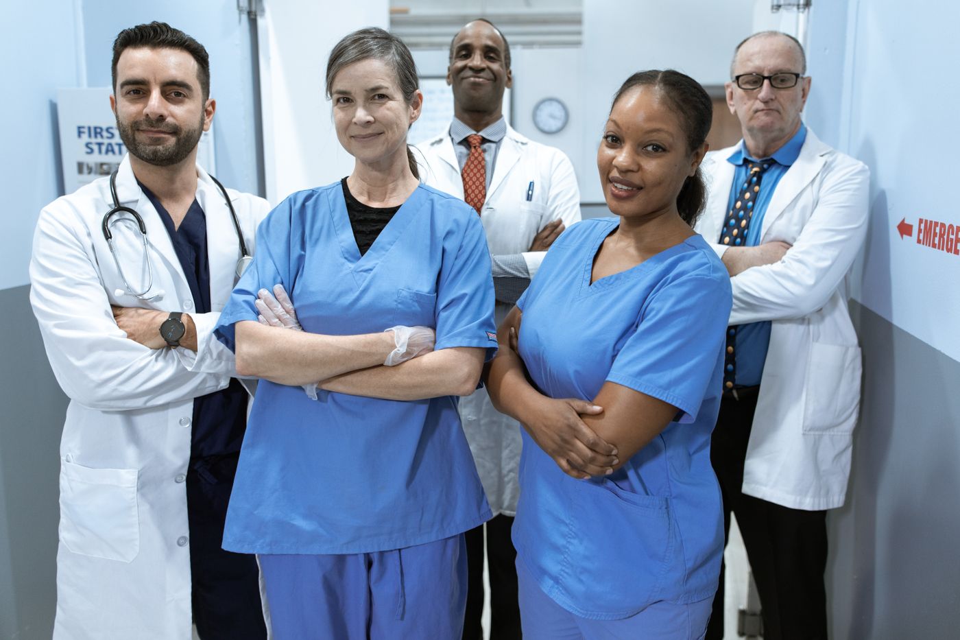 Confident hospital team of nurses and physicians standing together