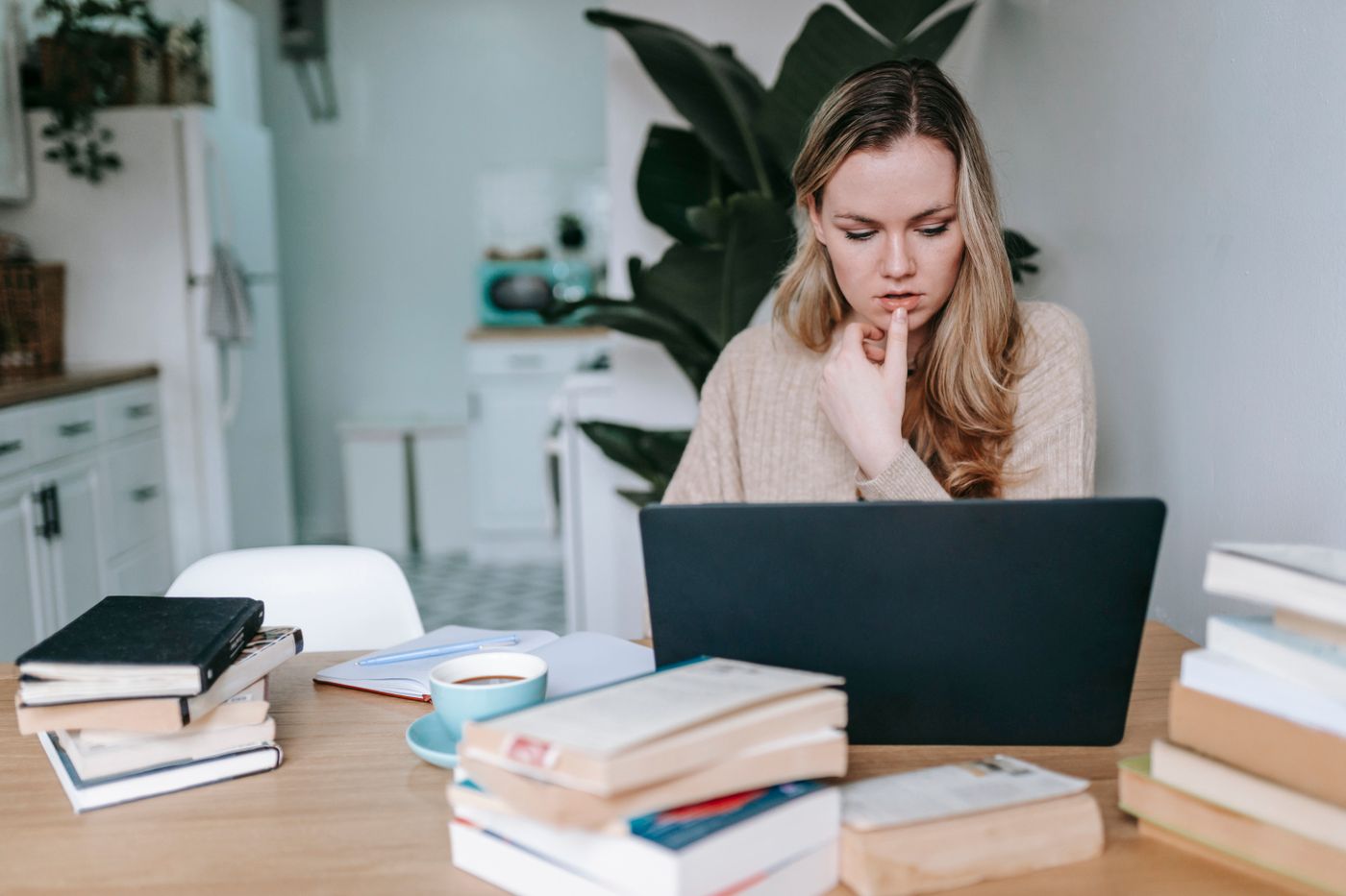 Nursing student studying with laptop and books