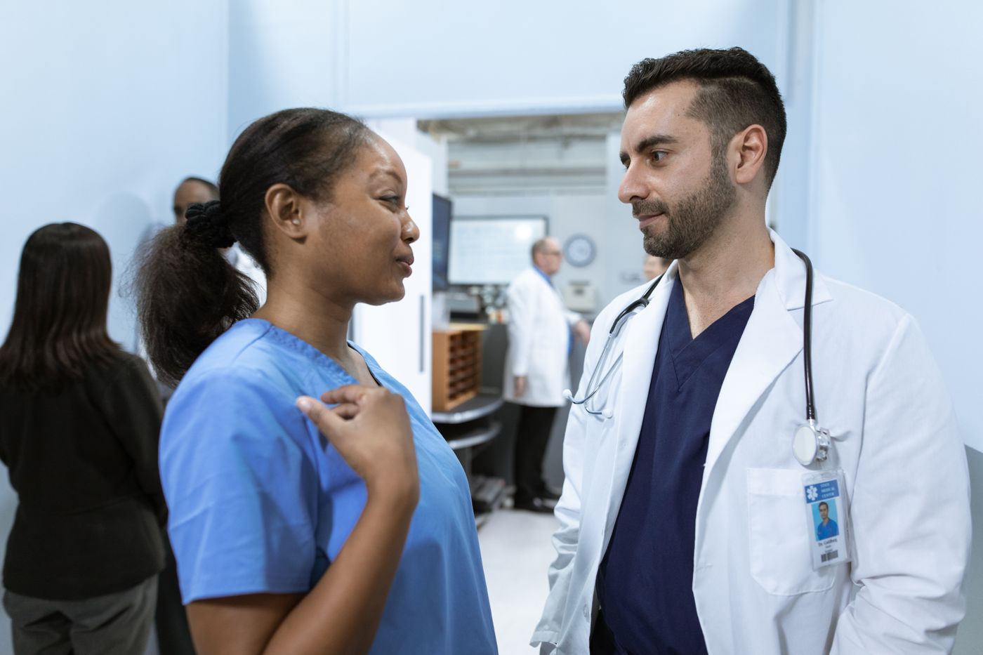 Nurse and physician in a handoff conversation at a hospital